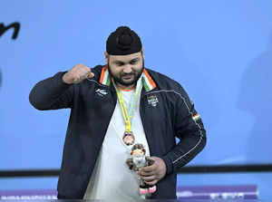Birmingham: Indian weightlifter Gurdeep Singh with the bronze medal in the men’s...