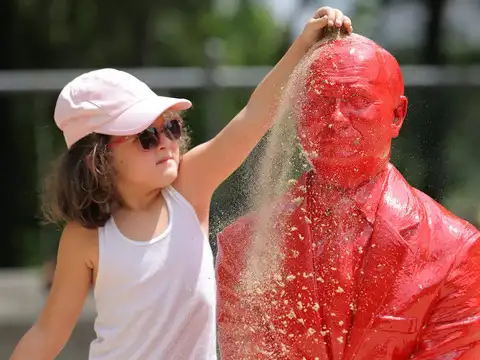 ​A child pours sand