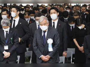 UN Secretary General Antonio Guterres, center, observes a minute of silence during the ceremony marking the 77th anniversary of the atomic bombing at Hiroshima