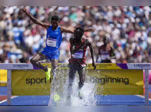 Abraham Kibiwot, of Kenya right, leads Avinash Mukund Sable of India competes in...