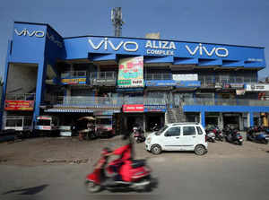 FILE PHOTO: A scooterist rides past a shopping complex with the billboard of Chinese smartphone maker Vivo in Ahmedabad