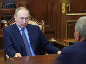 Russian President Vladimir Putin listens to Yuri Borisov, the new CEO of the Rus...