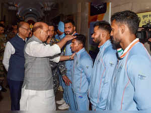 New Delhi: Defence Minister Rajnath Singh with sportspersons from the Armed Forc...
