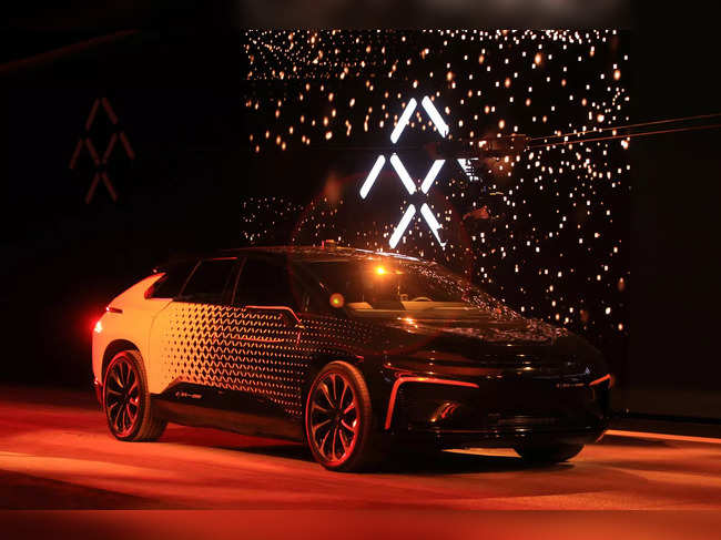 A Faraday Future FF 91 electric car arrives on stage for an exhibition of speed during an unveiling event at CES in Las Vegas