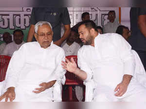Patna: Bihar Chief Minister Nitish Kumar in a conversation with Deputy CM Tejashwi Yadav to pay tribute to freedom fighters during the martyrs day at Shaheed Smarak , in Patna, Thursday, Aug 11, 2022. (Photo: IANS)