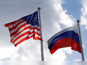FILE PHOTO: Russian and U.S. state flags fly near a factory in Vsevolozhsk
