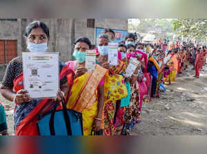 Nadia: Beneficiaries show their Aadhaar Card as they wait in a queue to receive ...