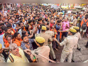 Varanasi: Police try to control devotees waiting outside the Kashi Vishwanath te...