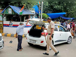 New Delhi, Aug 11 (ANI): A policeman checks a car at Sarojini Nagar market as se...