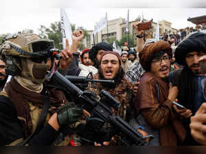 Taliban supporters rejoice on the first anniversary of the fall of Kabul on a street in Kabul