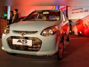FILE PHOTO: Officials stand next to the newly launched Maruti Suzuki Alto 800 car in Ahmedabad