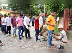 Tezpur: Assam Police personnel check candidates as they arrive to appear in clas...