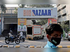 People move past a Future Retail's closed Big Bazaar retail store in Mumbai