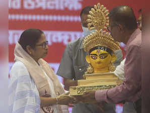 Kolkata:West Bengal Chief Minister Mamata Banerjee receives an idol of Goddess Durga during the administrative meeting with different Durga Puja organizers for upcoming Durga Puja festival in Kolkata on Monday August 22,2022.(Photo:IANS)