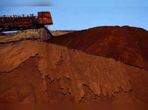 FILE PHOTO: A stacker unloads iron ore onto a pile at a mine located in the Pilbara region of Western Australia
