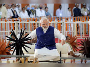 Ahmedabad, Aug 27 (ANI): Prime Minister Narendra Modi spins charkha at 'Khadi Ut...