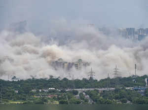 Noida: Dust covers the area after demolition of Supertech's twin towers in Noida...