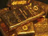 Gold dips as dollar fims on Powell's hawkish tone weigh