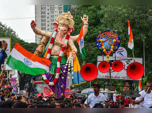 Devotees carry an idol of Lord Ganesh to pandal for the upcoming Ganesh ...