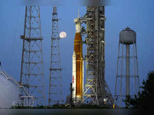 FILE - The moon sets in front of the NASA Artemis rocket with the Orion spacecra...