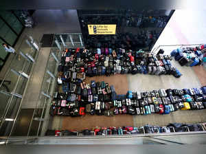 FILE PHOTO: Lines of passenger luggage lie arranged outside Terminal 2 at Heathrow Airport in London