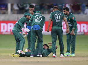 Pakistan's Naseem Shah lies on the ground as he struggles due to cramps during t...