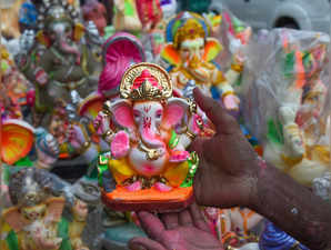 New Delhi: An artisan gives final touches to a Ganesha idol ahead of the festiva...