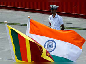 FILE PHOTO: A Navy officer stands in front of India's and Sri Lanka's national flags as Indian Coast Guard Ship Shoor is in the Colombo port during its visit in Colombo