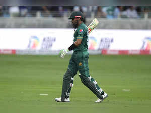 Pakistan's captain Babar Azam leaves the field after losing his wicket during th...