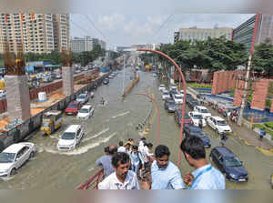 Bengaluru: Vehicles pass through the waterlogged Outer Ring Road after heavy mon...