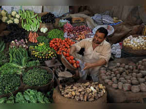 A vendor sells vegetables at a stall, in Peshawar