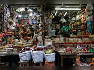 Vendors wait for customers at their respective shops at a retail market in Kolkata