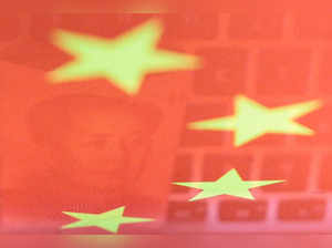 FILE PHOTO: Illustration picture of China yuan banknote and computer keyboard reflected on Chinese flag