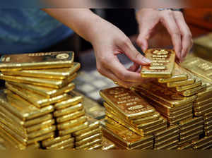 Gold hovers near two-year low as rate-hike fears persist