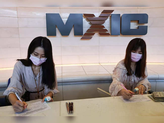 Members of staff register guests at the Macronix headquarters lobby, at Hsinchu Science Park in Hsinchu