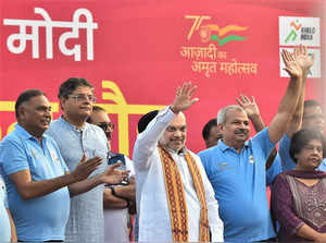 New Delhi: Union Home Minister Amit Shah and Delhi BJP President Adesh Gupta wav...