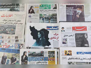 Newspapers with a cover picture of Mahsa Amini, a woman who died after being arrested by the Islamic republic's "morality police" are seen in Tehran