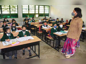 Dibrugarh: Students attend a class at their school after it was reopened for nur...