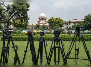 New Delhi: Tripods belonging to media personnel at the lawns of Supreme Court du...