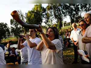 Jews blow horns as part of a Jewish ceremony on a Rosh Hashanah afternoon, the Jewish New Year, by the Yarkon river in Tel Aviv