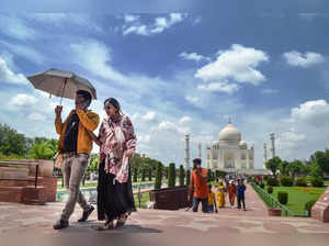 Agra: Tourists visit the Taj Mahal as clouds hover in the sky above the monument...