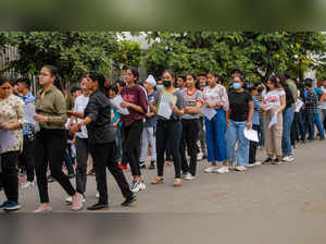 Noida: Students wait in a queue to appear in Common University Entrance Test (CU...