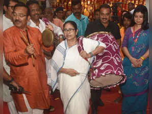 Kolkata: West Bengal Chief Minister Mamata Banerjee beating a drum during the inauguration of Suruchi Sangha puja pandal ahead of the Durga Puja festival in Kolkata on Wednesday, Sept. 28, 2022. (Photo:IANS)