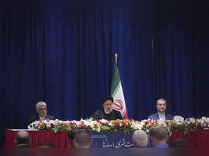 Iran President Ebrahim Raisi, center, holds a news conference on his visit for t...