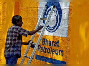 FILE PHOTO: FILE PHOTO: A man paints the logo of oil refiner Bharat Petroleum Corp on a wall on the outskirts of Kochi