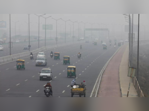Vehicles are seen on a highway on a smoggy morning in New Delhi
