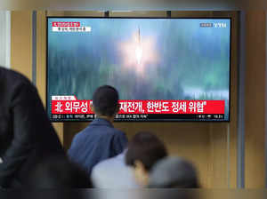 A TV screen showing a news program reporting about North Korea's missile launch ...