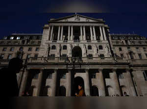 People walk outside the Bank of England in London