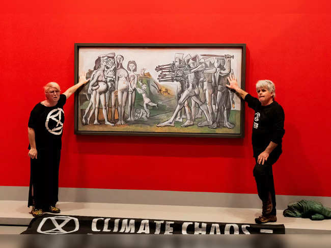 Climate protesters from Extinction Rebellion glued themselves to Picasso's "Massacre in Korea" at the NGV in Melbourne