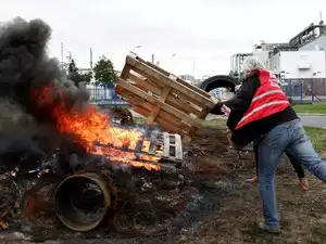 FILE PHOTO: Workers on strike burn a fire in front of the ExxonMobil oil refinery in Port-Jerome-sur-Seine